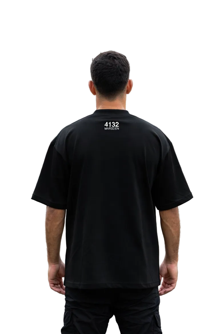 Person wearing a black t-shirt with '4132' printed on the back, standing in a suburban neighborhood.