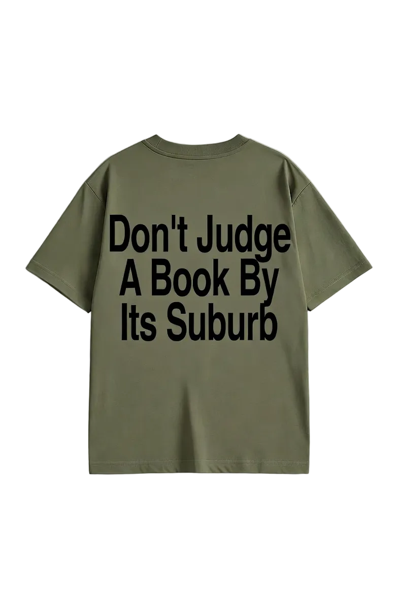 Green t-shirt with text 'Don't Judge A Book By Its Suburb' on a light gray background