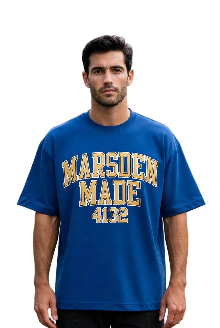 Man wearing a blue t-shirt with 'Marsden Made 4132' text standing on a road white background.