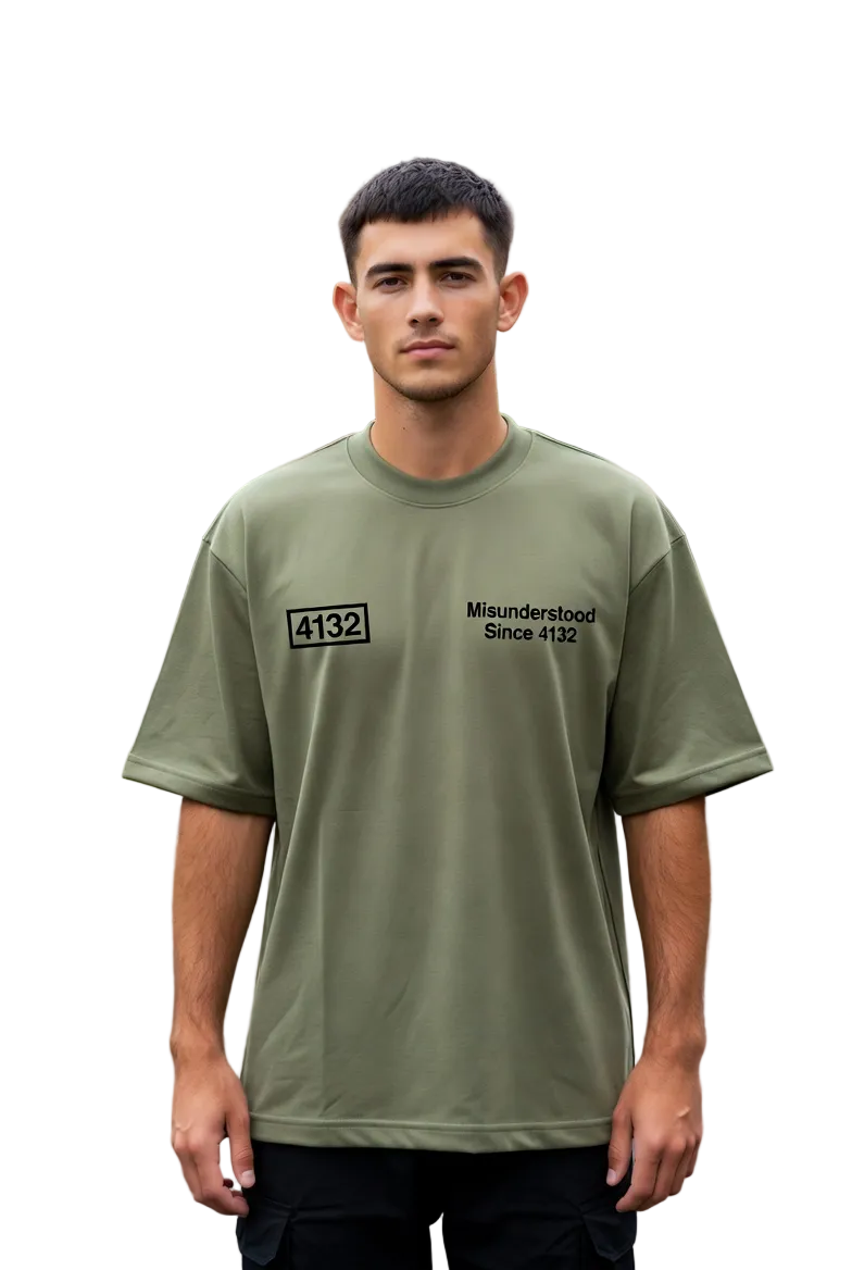 Man wearing a green t-shirt with text standing on a street