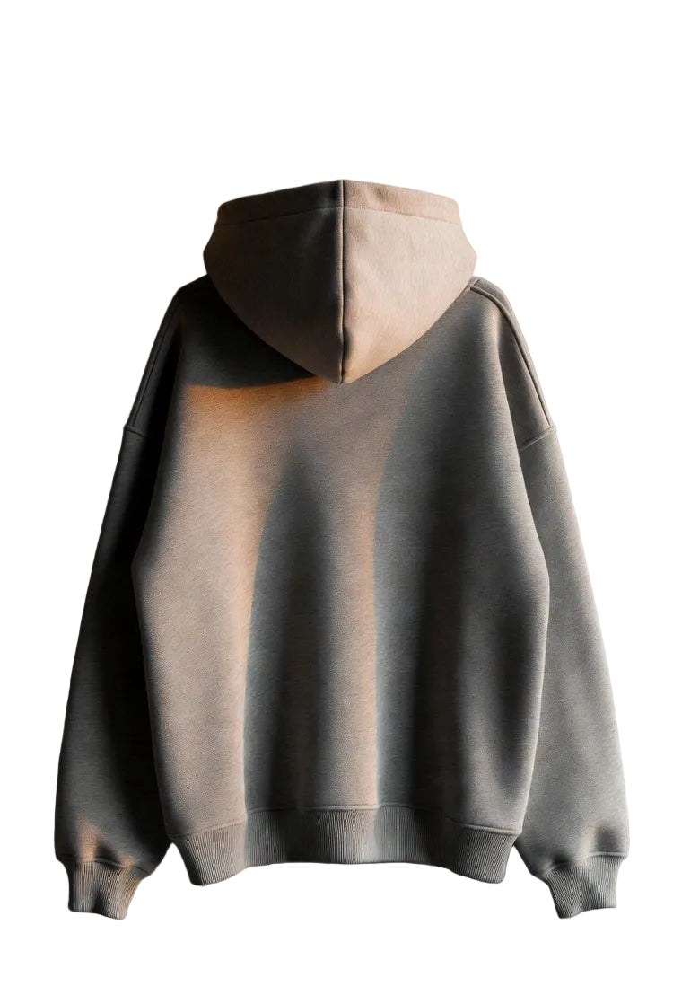 Hoodie with a two-tone design hanging against a white wall.