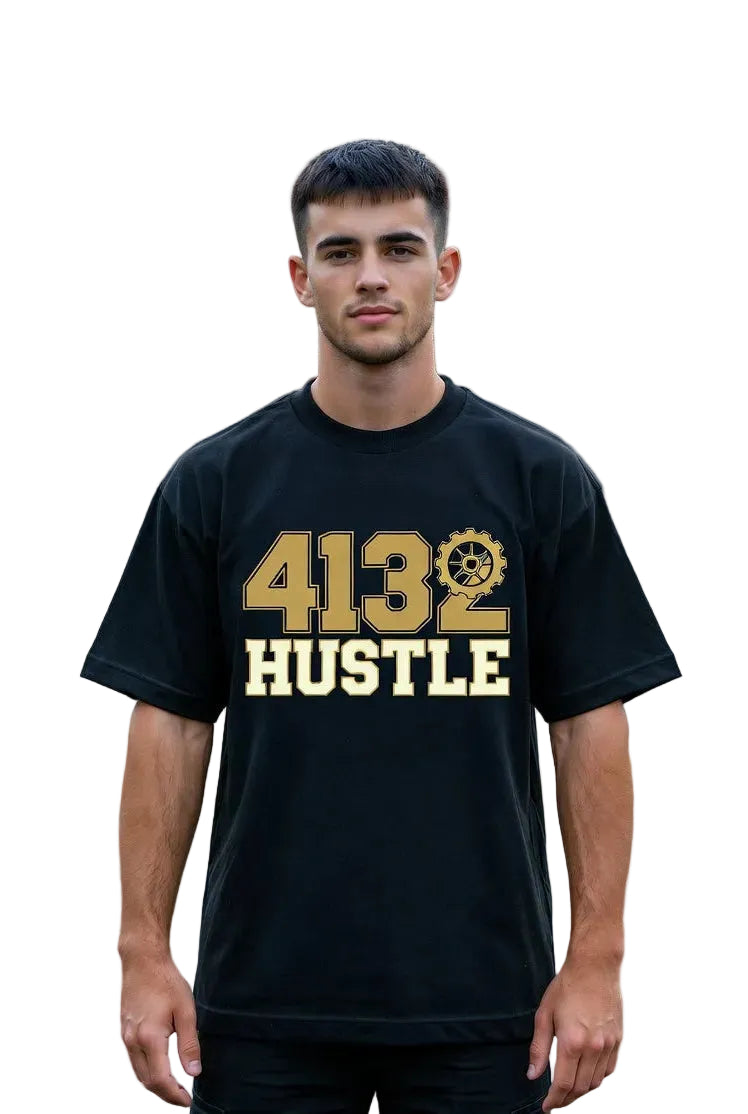 Man wearing a black t-shirt with '4132 HUSTLE' printed on it, standing in front of a house.