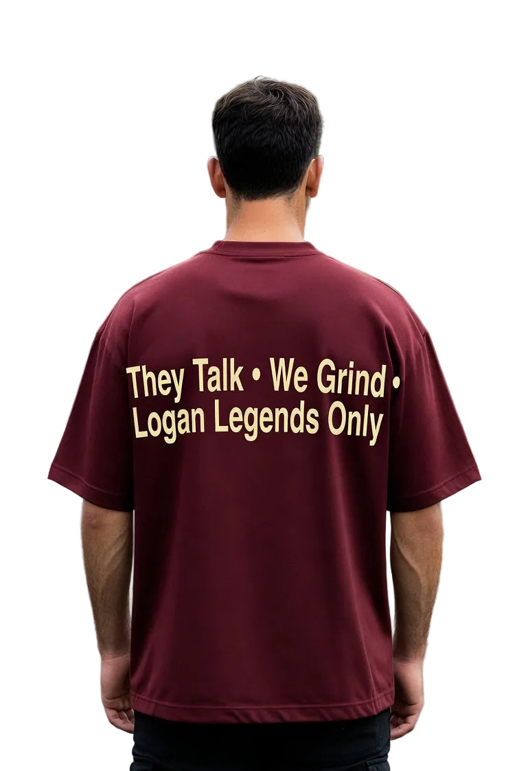 Person wearing a maroon t-shirt with text on the back, standing outdoors.