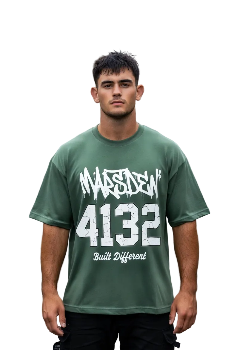 Man wearing a green t-shirt with text standing on a street